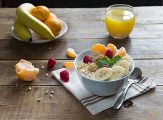 oatmeal with bananas and nuts and orange juice and fruit