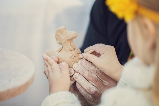 Teacher and kid potters at workshop