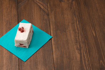 cake with fresh cherry on wooden background