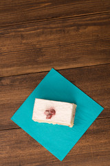 cake with fresh cherry on wooden background