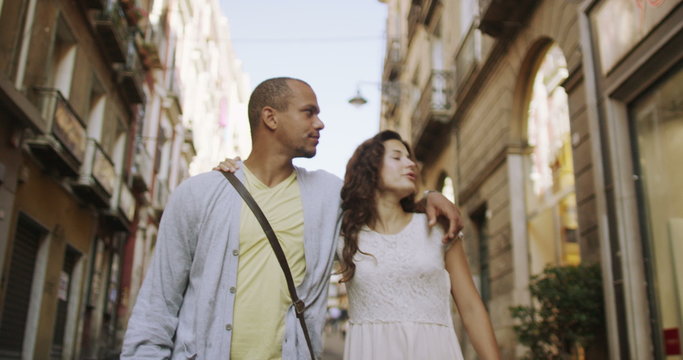  Happy attractive couple window shopping in Italian town. 