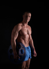 Fototapeta na wymiar Bodybuilding. Studio photo of smiling athlete