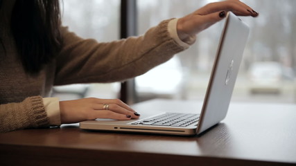 Woman closes the laptop and goes out - Powered by Adobe