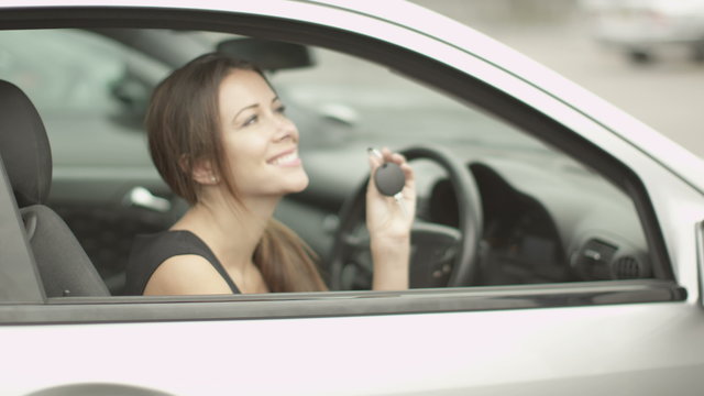  attractive young woman receives keys for her new car