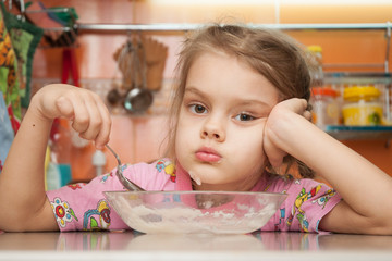  Five-year girl eats porridge sad