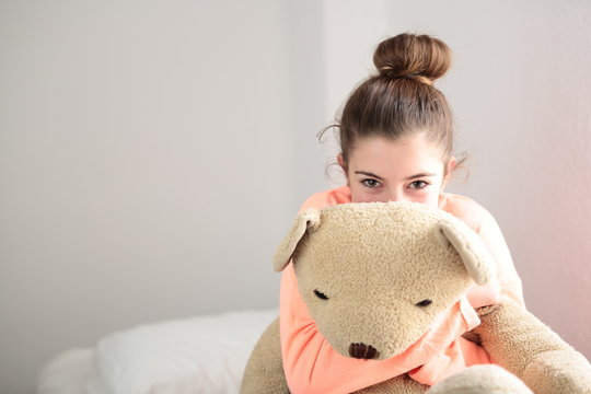 Teen Hugging Her Teddy Bear In Her Room
