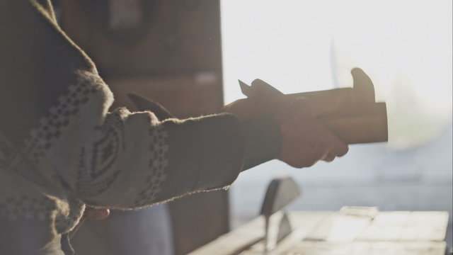 Old carpenter working with wood. Settings hand plane.