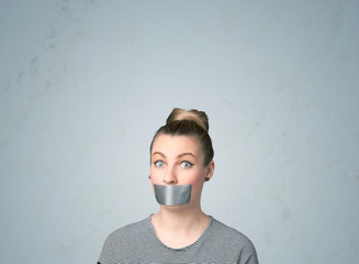Young woman with glued mouth
