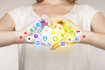 Hands creating a form with mobile app icons