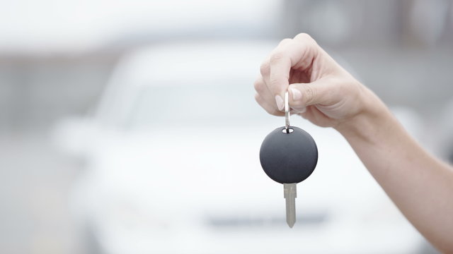 Close up of hand dangling keys to a new car