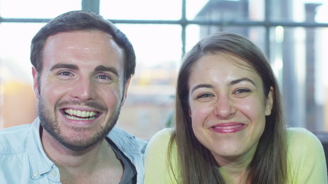 Attractive young couple having a video chat announcing their engagement