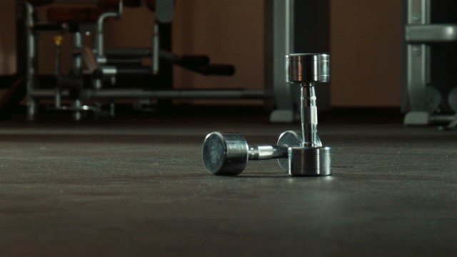 two dumbbells in gym