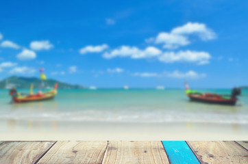 Fototapeta na wymiar Blur tropical beach with old empty wood table background.