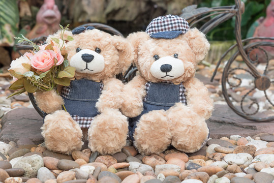 two teddy bears on garden background