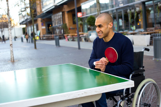 young man in a wheelchair playing table tennis