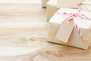 gift box with red strip ribbon and tag on wood table 