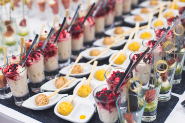 Beautifully decorated catering banquet prepared table with different food snacks and appetizers...