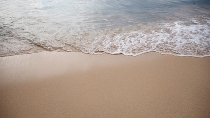 Soft white wave of the sea on the sandy beach at Phuket, Thailand. Copy space for some text.