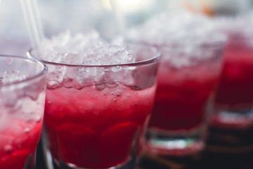 Beautiful row line of different colored alcohol cocktails with mint on a christmas party, martini, vodka with bubbles, wine and others on decorated catering bouquet table on open air event, picture 