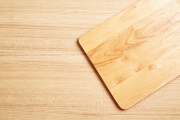 Naklejka na ściany i meble Empty cutting board on planks food background concept