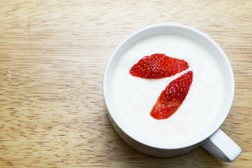 strawberry and yogurt on wood table