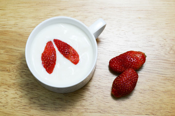 strawberry and yogurt on wood table