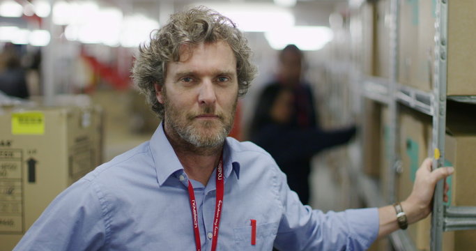 Portrait of business manager in a warehouse or factory