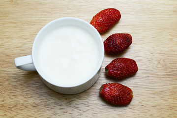 strawberry and yogurt on wood table