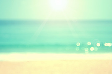 Fototapeta na wymiar Blur tropical sunset beach with bokeh wave sun light abstract background.