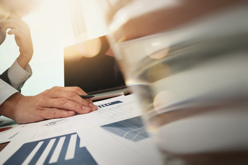 business documents on office table and laptop computer and graph