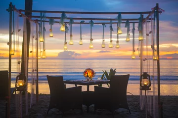 Papier Peint photo Lavable Mer / coucher de soleil romantic dinner setup on the beach
