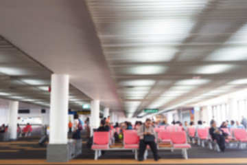 Defocus blurred picture of travellers, passengers waiting for their flight at airport