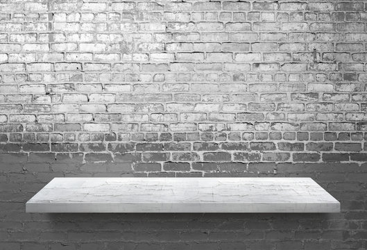 White wooden shelf on white brick wall