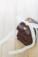 Decorated chocolate brownies with walnut  on white wood backgrou