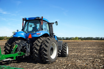 Obraz premium Tractor with plow working in the field