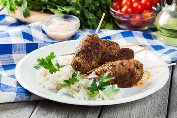 Barbecued kofta with rice on a plate