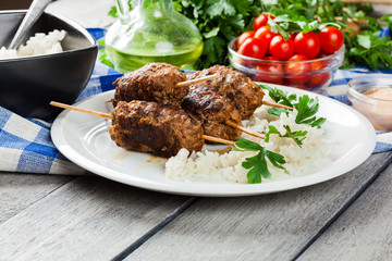 Barbecued kofta with rice on a plate