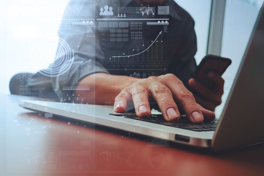 Close up of business man hand working on laptop computer with di