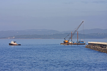 Fototapeta premium Tug pulling Crane