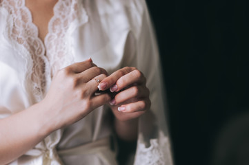 Obraz na płótnie Canvas Woman tries on her beautiful ring