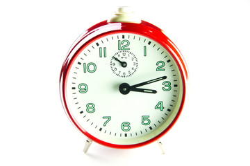 Red alarm clock on the white background.
