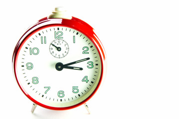 Red alarm clock on the white background.