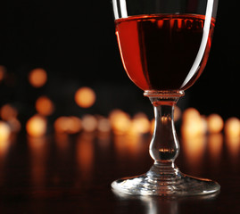 Wine glass with bokeh on dark background