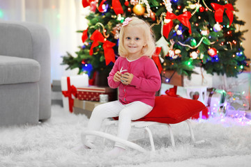 Funny girl  in living room and Christmas tree on background