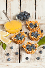  waffle baskets stuffed with lemon cream with blueberries.