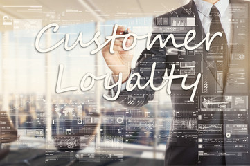 the businessman in the office is writing on the transparent board Customer Loyalty