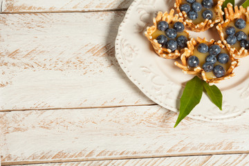  waffle baskets stuffed with lemon cream with blueberries.