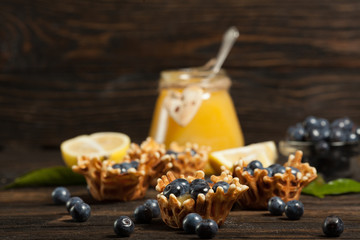  waffle baskets stuffed with lemon cream with blueberries.