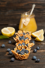waffle baskets stuffed with lemon cream with blueberries.