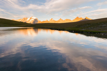 High altitude alpine lake, Gran Paradiso mountain range at sunset